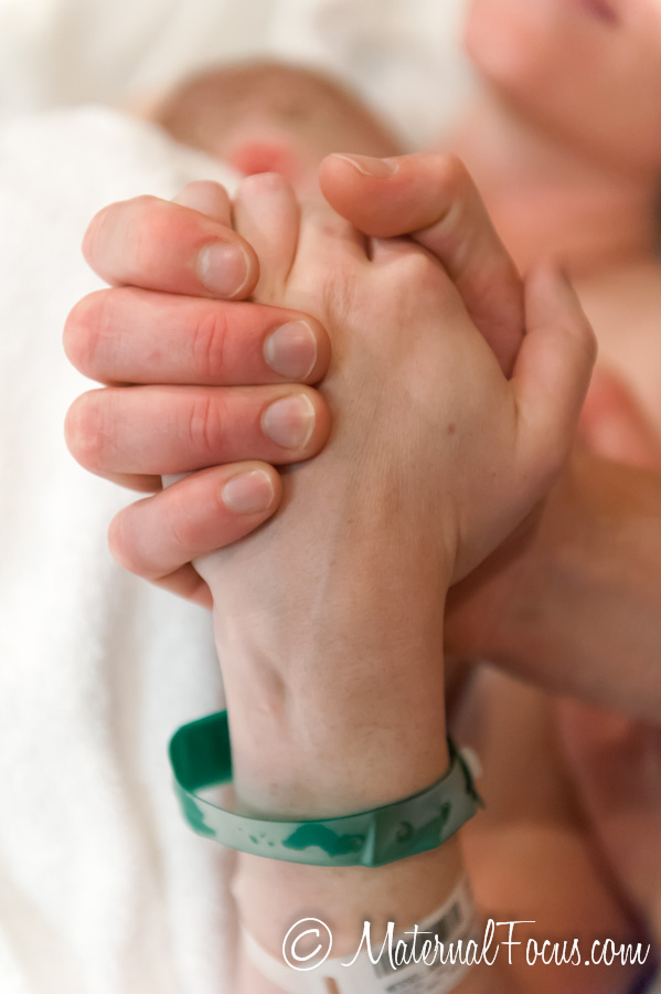 Parents holding hands during labor - doula supported birth