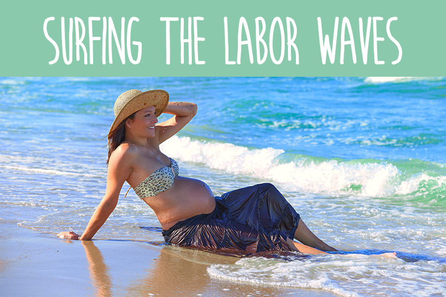 Pregnant woman sitting in ocean waves