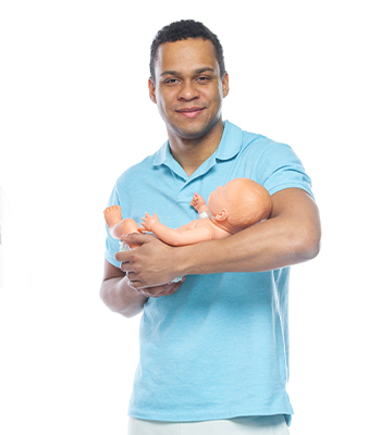 Teen boy holding fake newborn